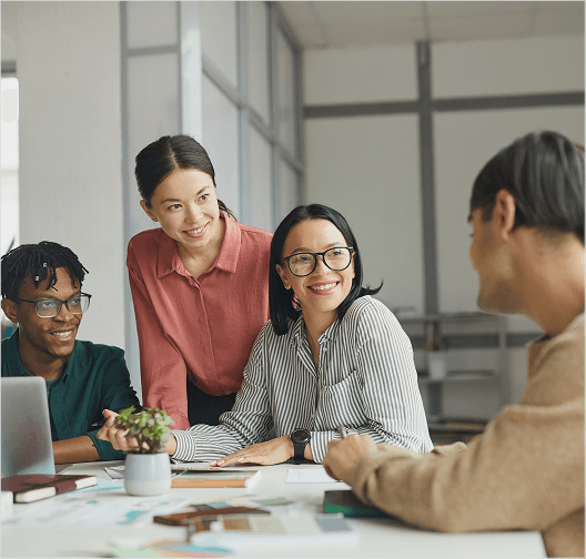 A Unicare care team reviewing participant plans together at a shared desk