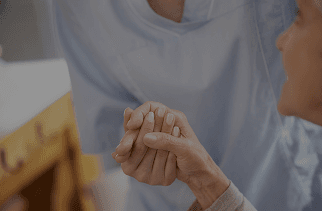 A clinician holding a participant’s hands during a visit